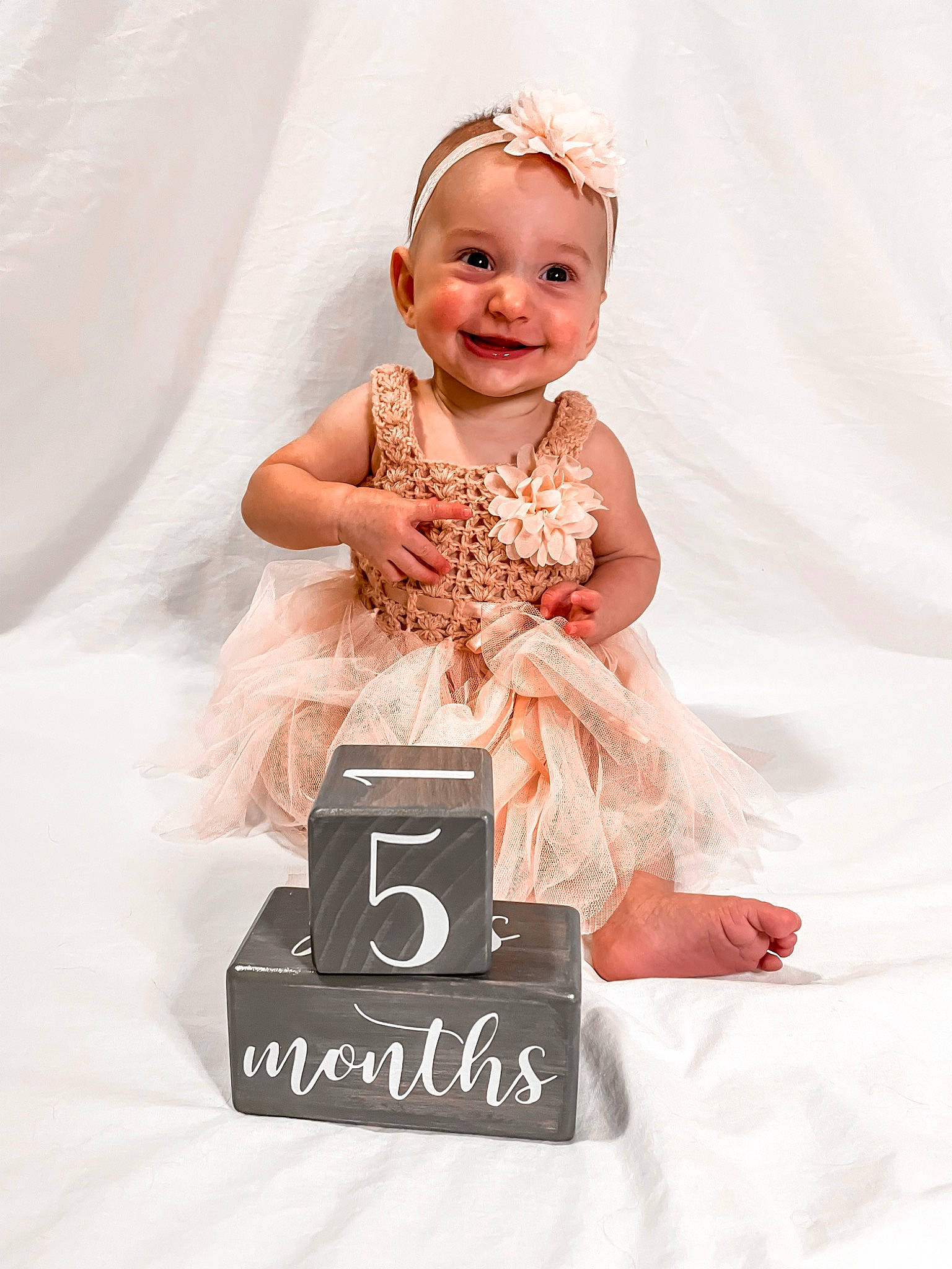 Tessah joined the competition — help win amazing prizes! baby, baby_toddler_clothing, child, dress, embellishment, face, facial_expression, fashion_accessory, flash_photography, happy, headband, headpiece, joy, peach, person, photograph, pink, sleeve, smile, toddler
