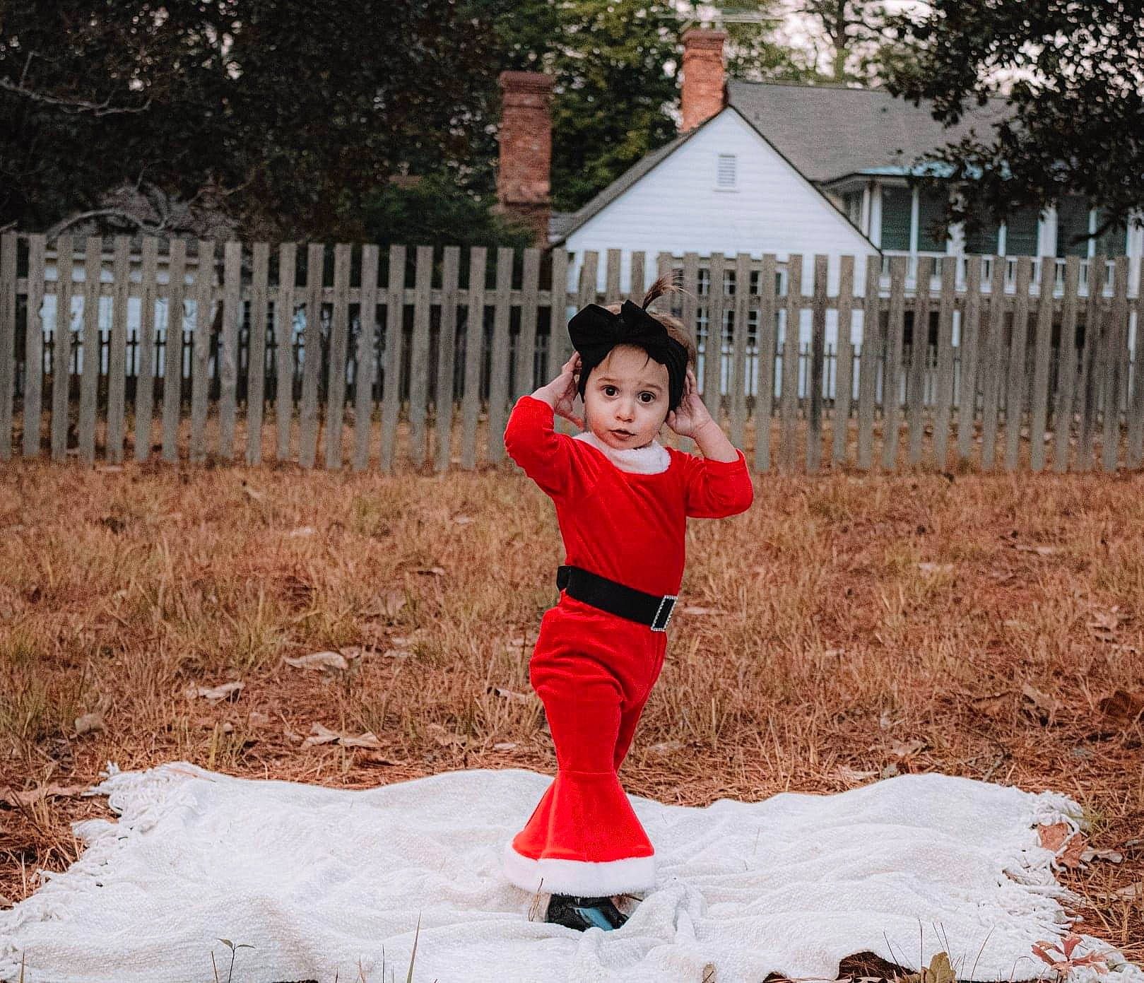 Tessah is registered to the contest to win money with this photo: child, fence, freezing, fun, grass, happy, headwear, home_fencing, leisure, outerwear, people_in_nature, person, plant, recreation, sitting, sleeve, snow, soil, spring, surprise