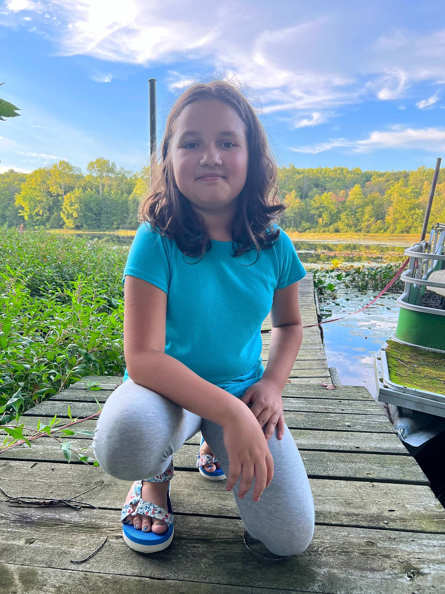 Evangeline is registered to the contest to win money with this photo: cloud, electric_blue, flash_photography, fun, grass, grassland, green, happy, human_leg, joy, leisure, people_in_nature, person, plant, recreation, sitting, sky, smile, summer, t_shirt