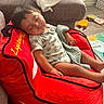 Blake joined the competition — help win amazing prizes! toddler, sleeping, bean_bag, red, race_car, flames, blanket, living_room, sofa, toy, floor, child, cozy, casual_clothing, infant, nap, home, furniture, relaxation, cute