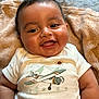 Blake joined the competition — help win amazing prizes! baby, infant, smile, happy, onesie, clothing, towel, face, portrait, cute, child, skin, hair, eyes, mouth, chubby, laying, indoors, soft, expression