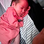 Paisley joined the competition — help win amazing prizes! baby, newborn, sleeping, infant, pink_clothing, blanket, striped, peaceful, cute, soft_lighting, face, foot, hand, portrait, closeup, rest, child, indoors, cozy, sleep