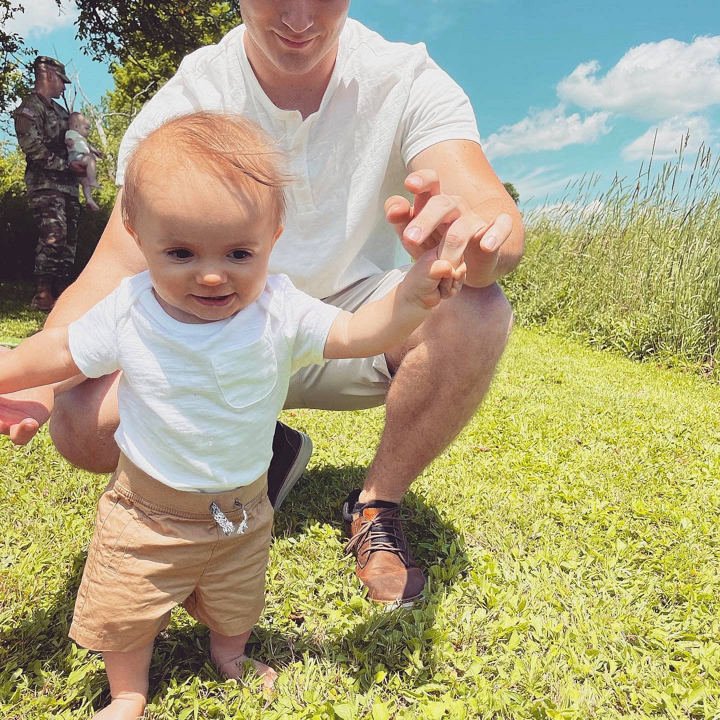Maxton is registered to the contest to win money with this photo: adaptation, cloud, finger, fun, gesture, grass, hand, happy, leg, leisure, people_in_nature, person, plant, shorts, sky, smile, summer, sunlight, thumb, toddler