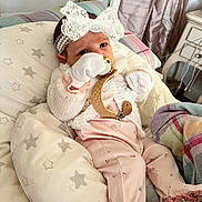 Aoife is registered to the contest to win money with this photo: baby, infant, pacifier, headband, lace, blanket, cushion, pajamas, knitted, white, pink, stars, indoor, cute, child, newborn, soft, comfort, portrait, resting