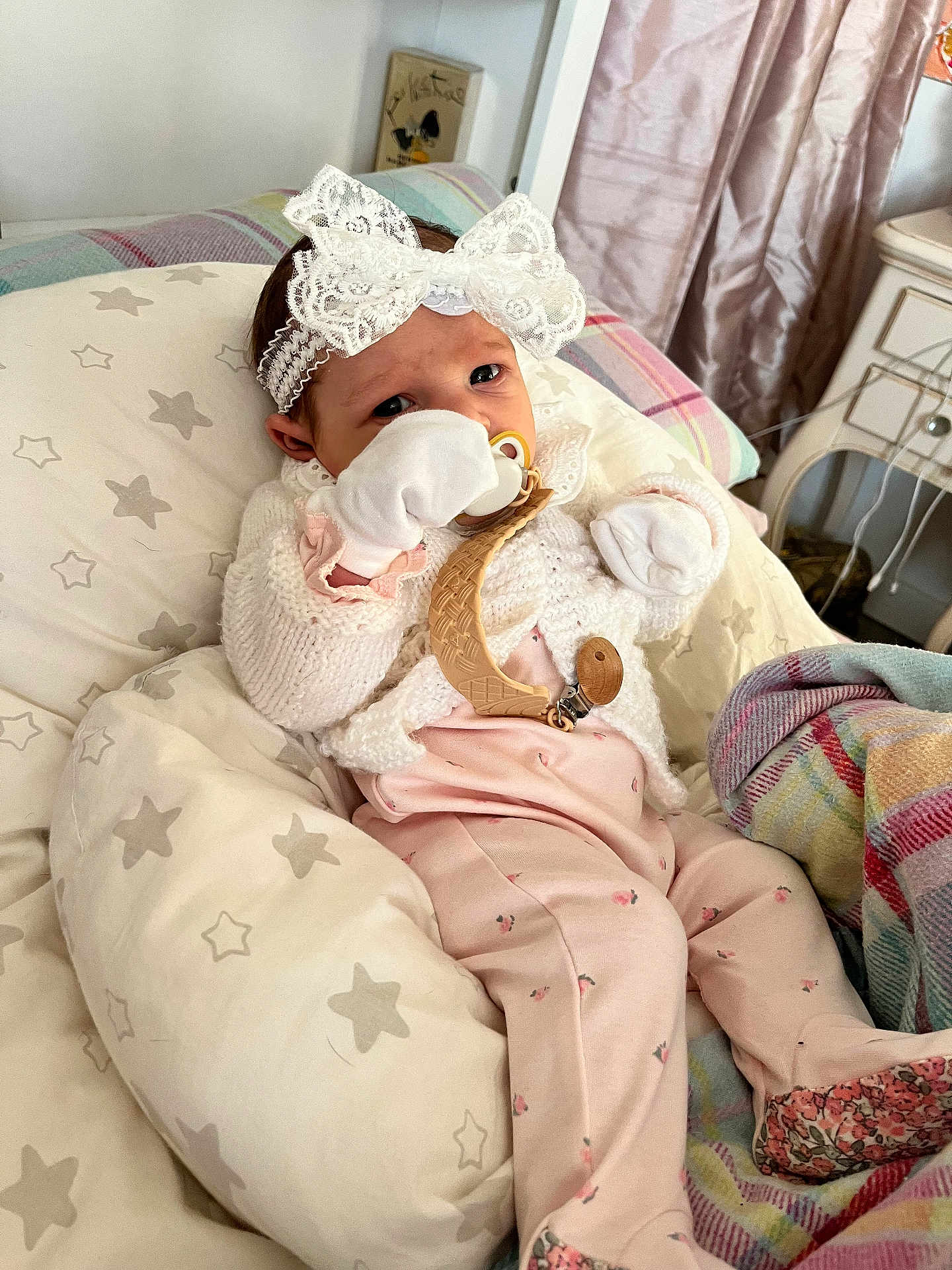 Aoife is registered to the contest to win money with this photo: baby, infant, pacifier, headband, lace, blanket, cushion, pajamas, knitted, white, pink, stars, indoor, cute, child, newborn, soft, comfort, portrait, resting