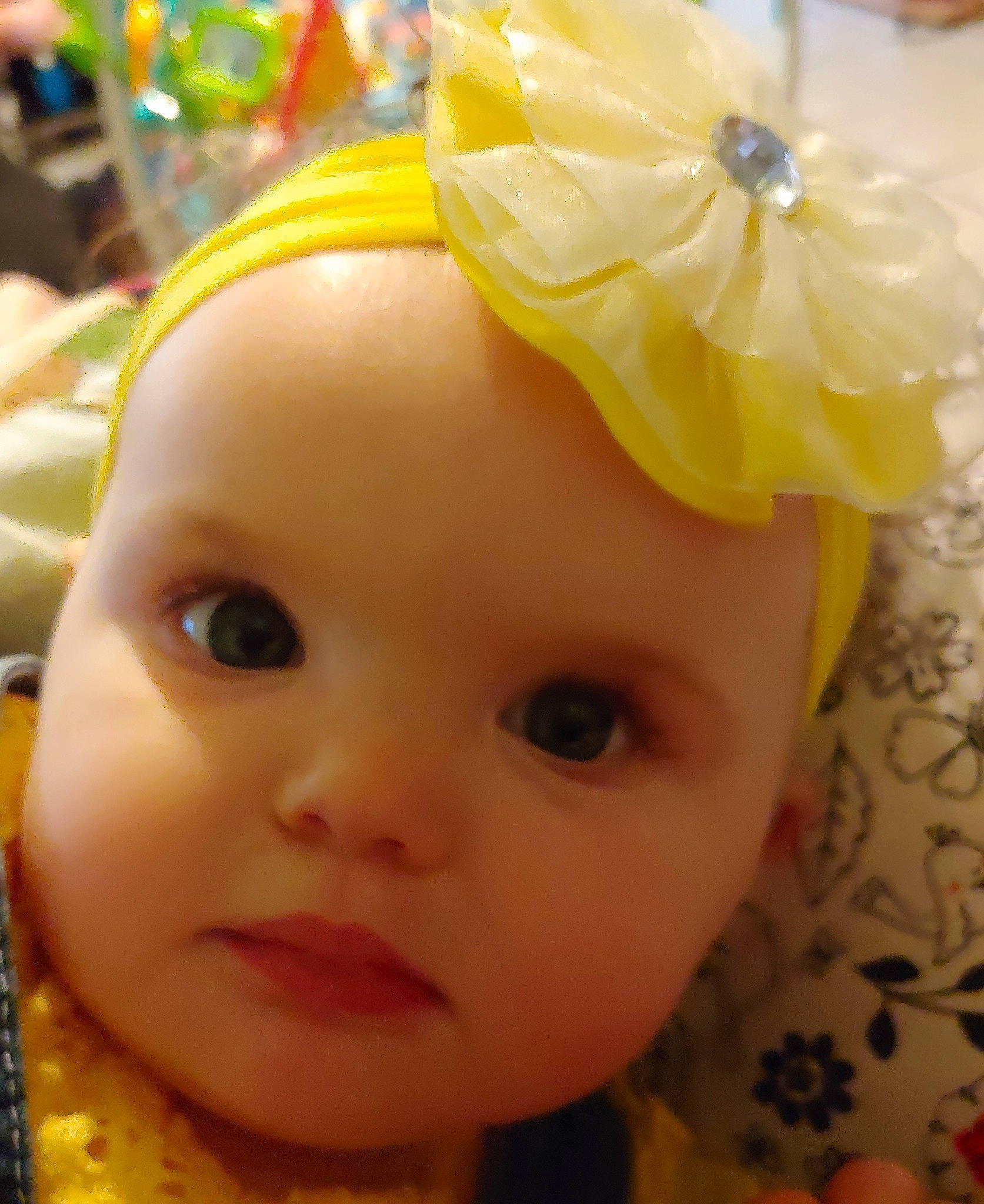 Madisyn is registered to the contest to win money with this photo: baby, cheek, child, face, fashion_accessory, forehead, hair_accessory, head, headband, headgear, headpiece, headwear, lip, mouth, person, skin, smile, toddler, yellow
