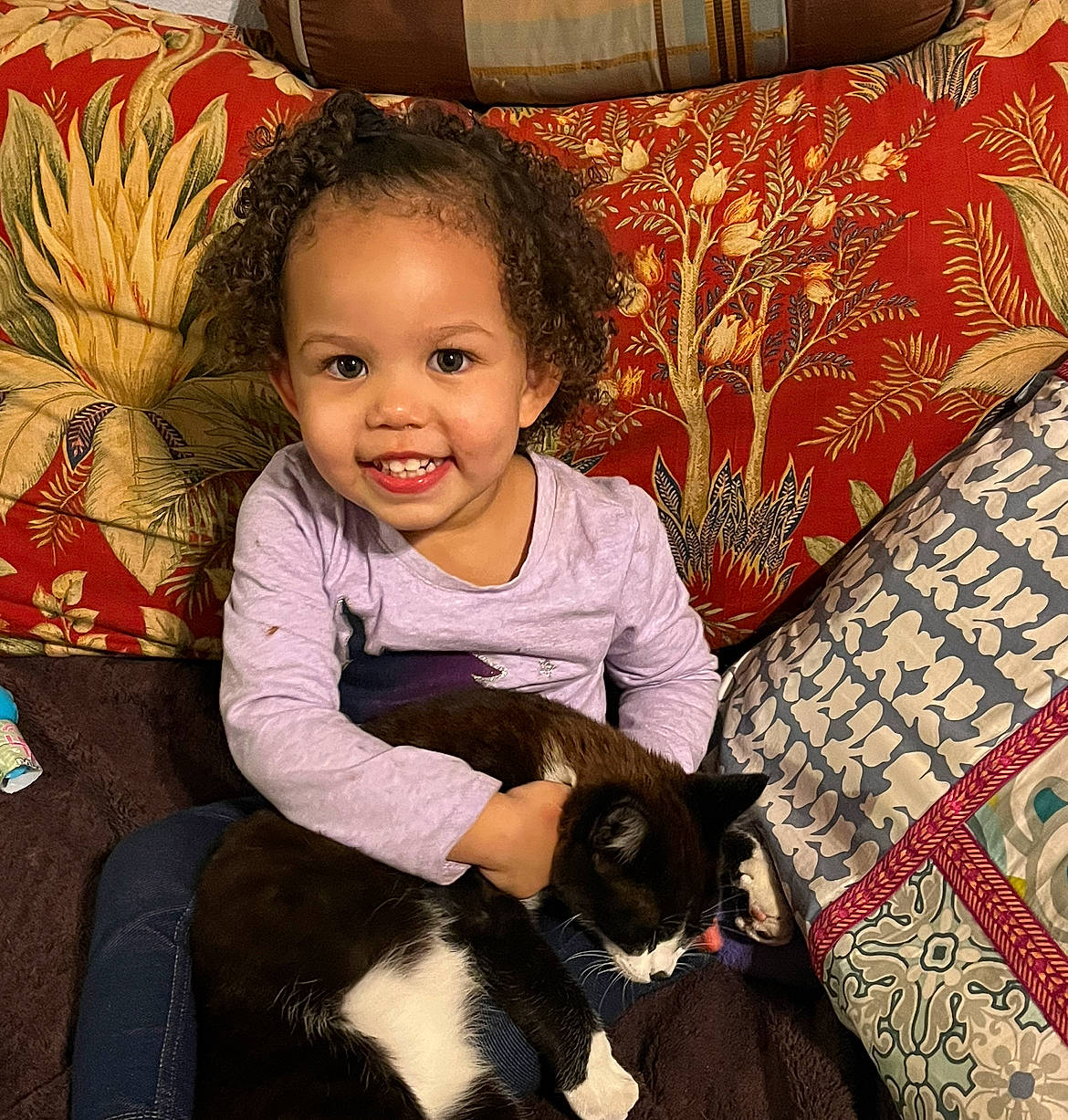Raiden is registered to the contest to win money with this photo: baby, baby_toddler_clothing, carnivore, cat, child, comfort, couch, felidae, flooring, happy, head, joy, lap, person, photograph, sitting, small_to_medium_sized_cats, smile, snapshot, textile