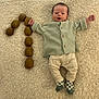 Edgar participe au concours pour gagner de l'argent avec cette photo : baby, infant, blanket, kiwi, fruit, number_one, clothing, socks, smile, happy, face, cute, celebration, cozy, lying_down, texture, soft, small_person, wearing, buttoned_shirt