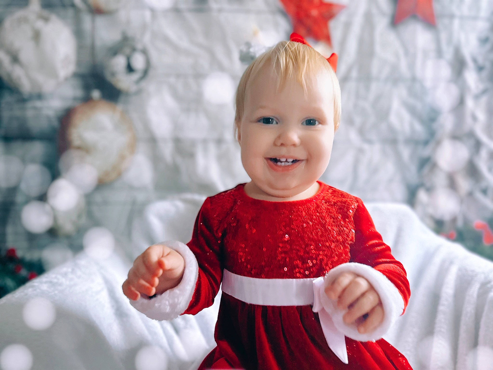 Freyja joined the competition — help win amazing prizes! baby, baby_toddler_clothing, child, christmas, christmas_eve, event, facial_expression, fun, gesture, happy, holiday, joy, people, person, portrait_photography, red, sitting, sleeve, smile, standing
