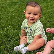 Jettson joined the competition — help win amazing prizes! baby, smiling, grass, outdoor, child, onesie, sitting, happy, cute, infant, feet, legs, greenery, sunlight, playful, nature, person, toddler, casual, summer