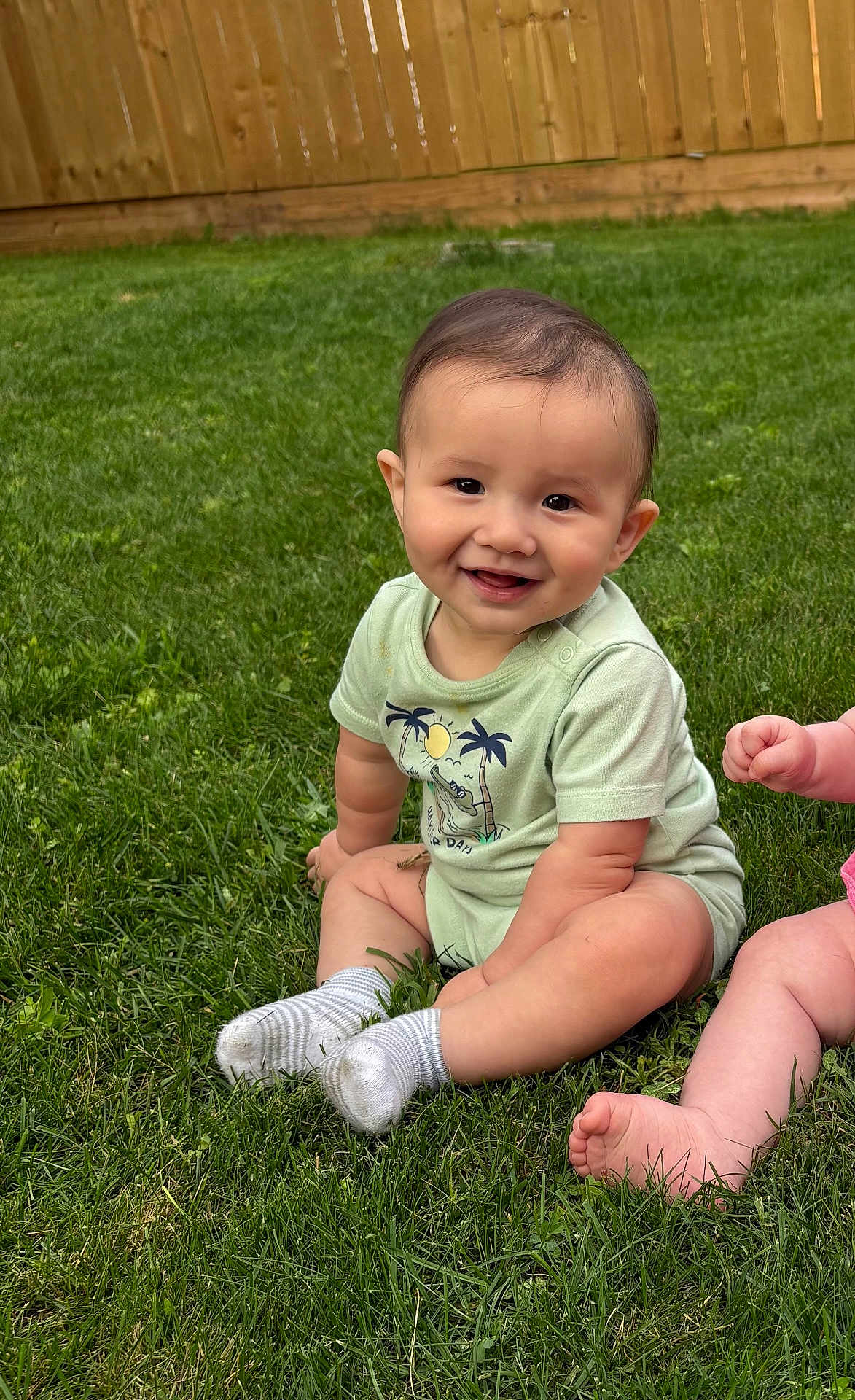 Jettson joined the competition — help win amazing prizes! baby, smiling, grass, outdoor, child, onesie, sitting, happy, cute, infant, feet, legs, greenery, sunlight, playful, nature, person, toddler, casual, summer
