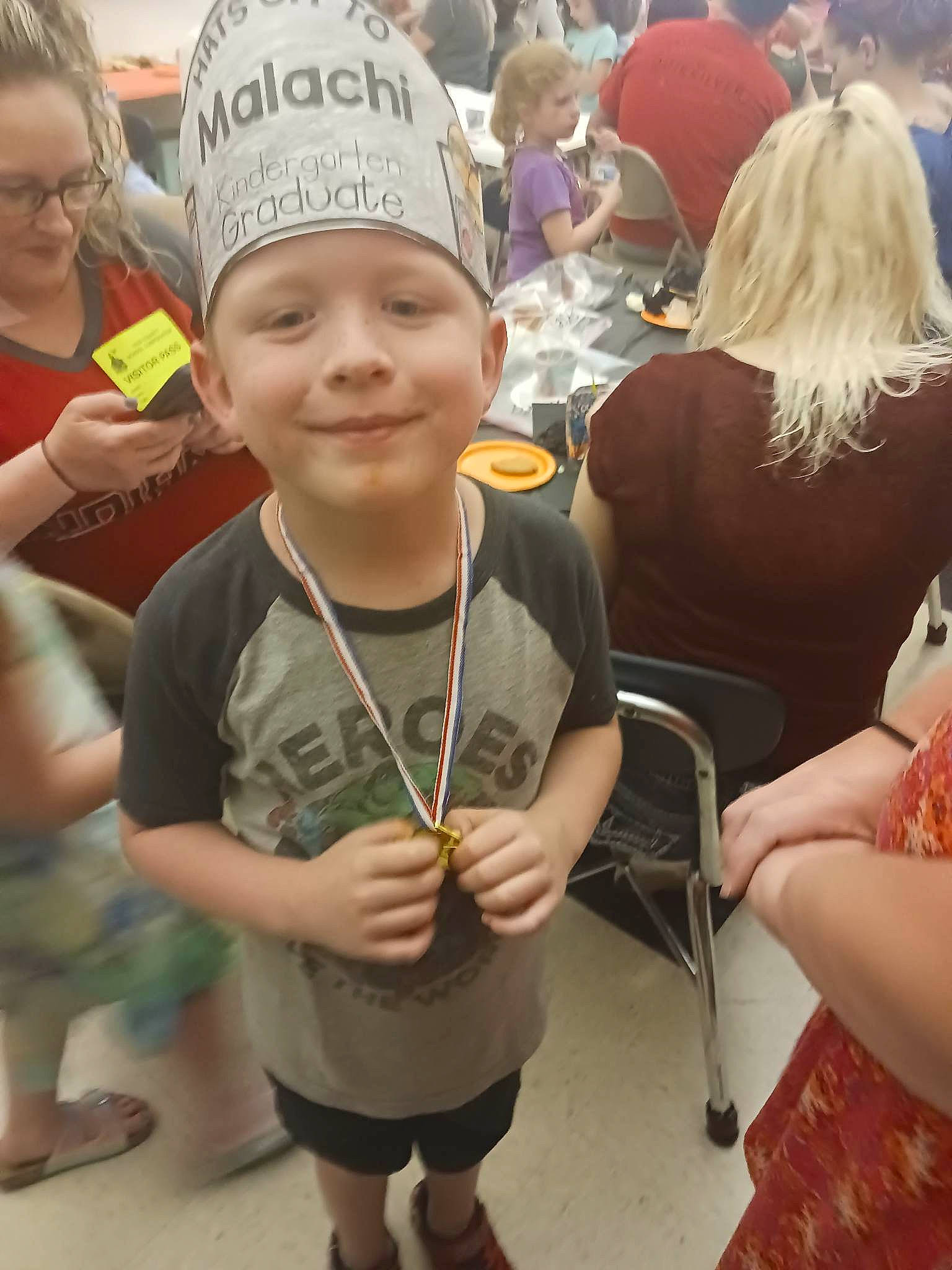 Malachi is registered to the contest to win money with this photo: baseball_cap, cap, chair, child, event, eyewear, fun, hairstyle, happy, headwear, jewellery, joy, leisure, necklace, person, personal_protective_equipment, recreation, sandal, shorts, smile