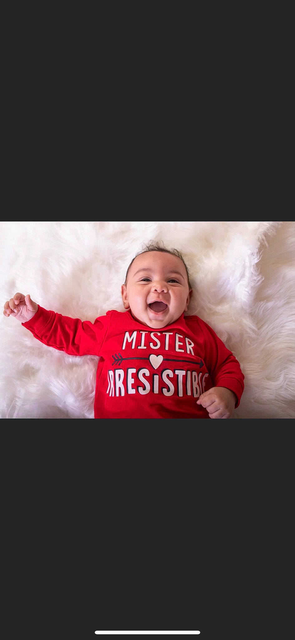 Sekani joined the competition — help win amazing prizes! baby, baby_toddler_clothing, child, comfort, eye, face, facial_expression, flash_photography, font, fur, gesture, happy, linens, magenta, monochrome_photography, person, sleeve, smile, t_shirt, textile