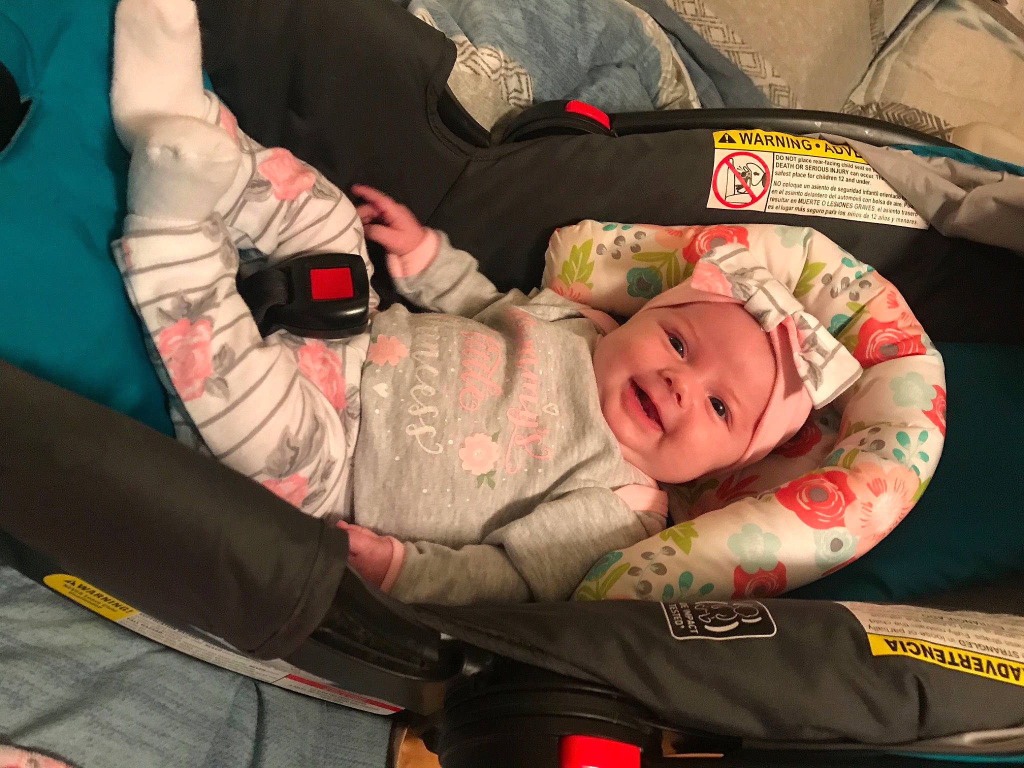 Emari is registered to the contest to win money with this photo: baby, baby_carriage, baby_products, baby_toddler_clothing, car_seat, carmine, child, comfort, elbow, event, flesh, fun, headwear, human_body, lap, mouth, person, room, sitting, smile