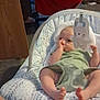 Brayden joined the competition — help win amazing prizes! baby, infant, baby_seat, thumb_sucking, toy, bunny_toy, red_chair, furniture, indoor, floor, blanket, patterned_fabric, person, home, relaxing, cute, child, legs, feet, casual