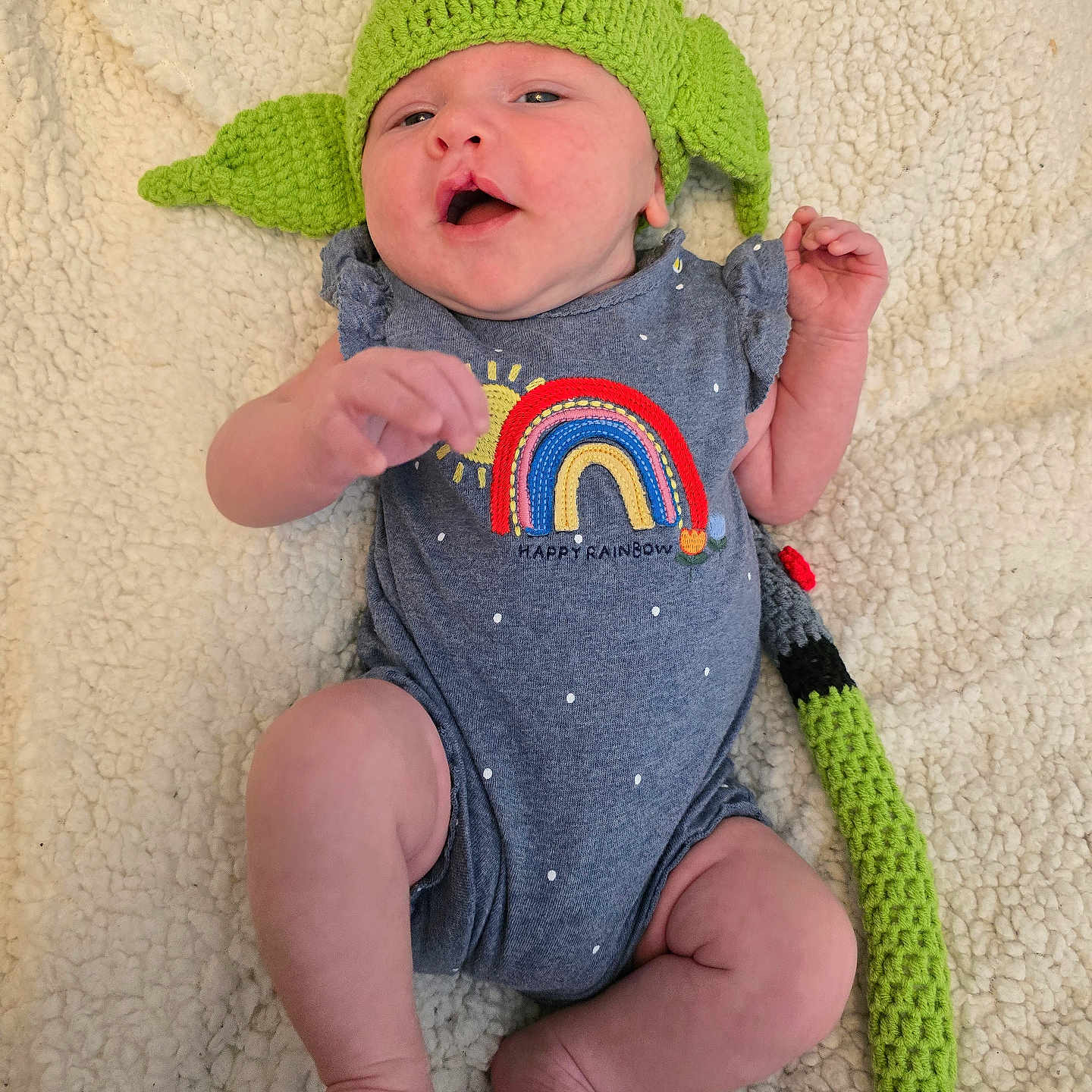 Elina Luna is registered to the contest to win money with this photo: applique, baby, beanie, bodypart, bonnet, cap, clothing, couch, face, finger, hand, hat, head, newborn, pattern, person, photography, portrait, sitting, t_shirt