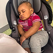 Isaiah is registered to the contest to win money with this photo: baby, sleeping, car_seat, child, infant, clothing, red_shirt, gray_pants, toddler, seatbelt, indoors, peaceful, cute, young_child, head_support, evenflo, portrait, resting, comfort, small_child