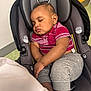baby, sleeping, car_seat, child, infant, clothing, red_shirt, gray_pants, toddler, seatbelt, indoors, peaceful, cute, young_child, head_support, evenflo, portrait, resting, comfort, small_child