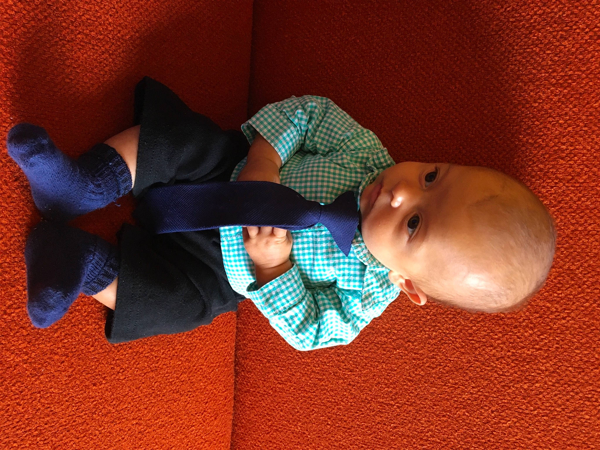 Hezekiah is registered to the contest to win money with this photo: baby, baby_products, baby_toddler_clothing, carmine, collar, comfort, electric_blue, fashion_accessory, fun, hat, linens, pattern, person, room, sleeve, sock, suit, tie, toddler, wood