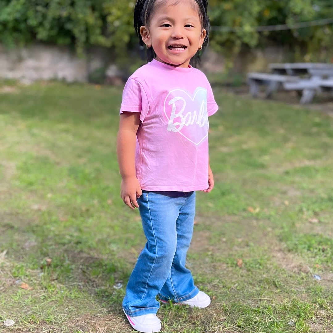 Darleth is registered to the contest to win money with this photo: backyard, child, clothing, face, female, girl, grass, happy, head, jeans, nature, outdoors, pants, park, person, photography, plant, portrait, standing, yard