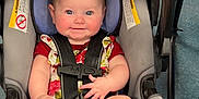 Remi joined the competition — help win amazing prizes! baby, infant, car_seat, child, smiling, blue_eyes, floral_outfit, bare_feet, seat_belt, cute, indoor, happy, chubby_cheeks, person, toddler, safety_harness, floor, playful, young_child, portrait