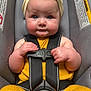 Remi joined the competition — help win amazing prizes! baby, child, car_seat, yellow_outfit, headband, bow, safety_harness, infant, cute, blue_eyes, chubby_cheeks, clothing, seatbelt, indoor, portrait, person, small_hands, car_safety, toddler, seat