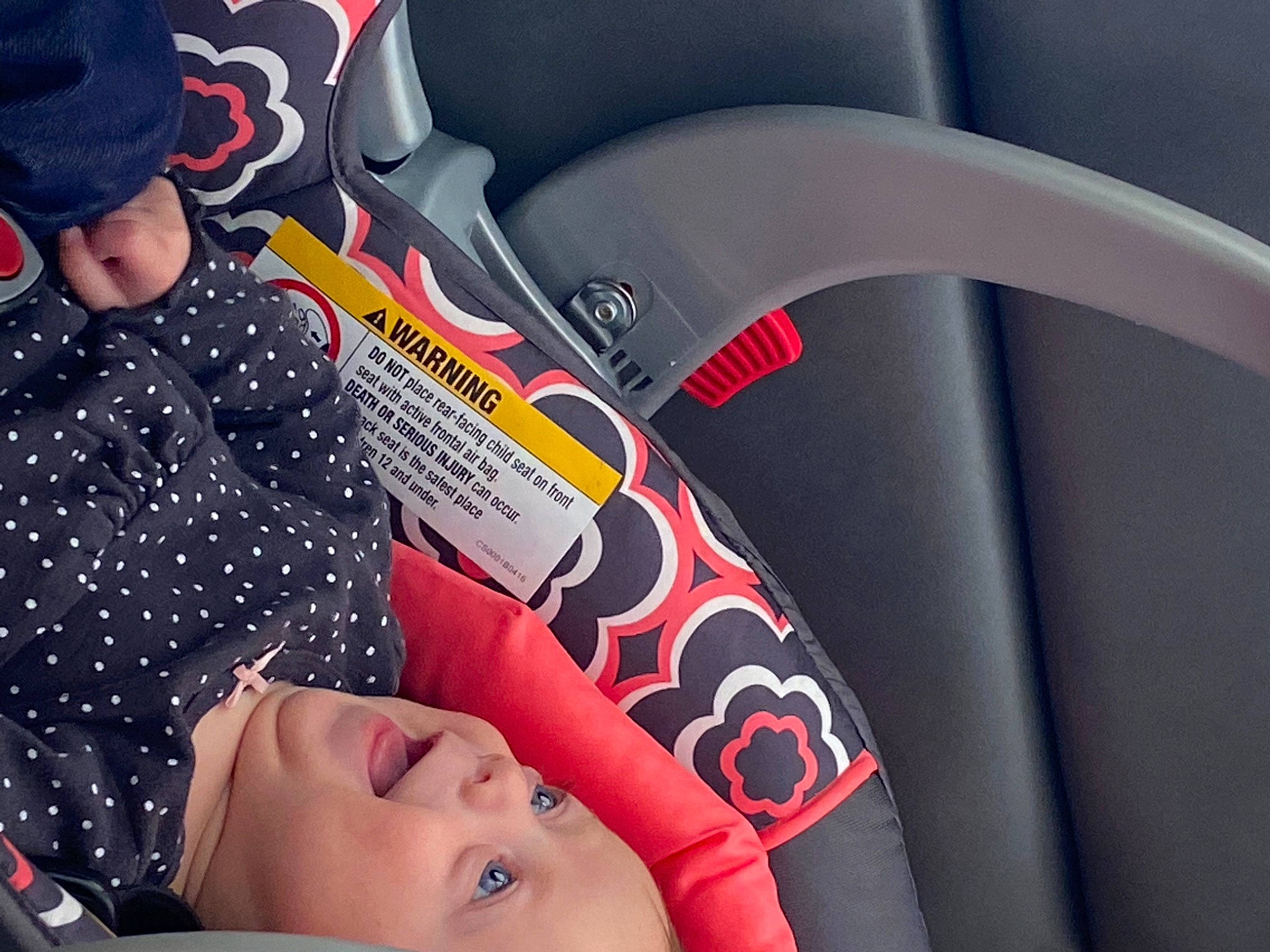 Ellie is registered to the contest to win money with this photo: audio_equipment, auto_part, automotive_design, automotive_tire, baby, baseball_cap, car_seat, carmine, comfort, cool, eyelash, finger, gesture, mouth, nail, person, personal_luxury_car, product, steering_wheel, toddler