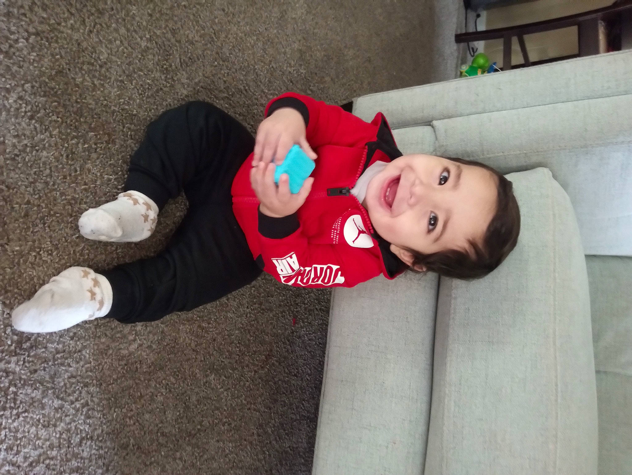 Julian joined the competition — help win amazing prizes! baby, baby_toddler_clothing, carmine, child, comfort, costume, flooring, fun, happy, hat, human_leg, joy, lap, leg, person, sitting, sleeve, smile, sock, thigh