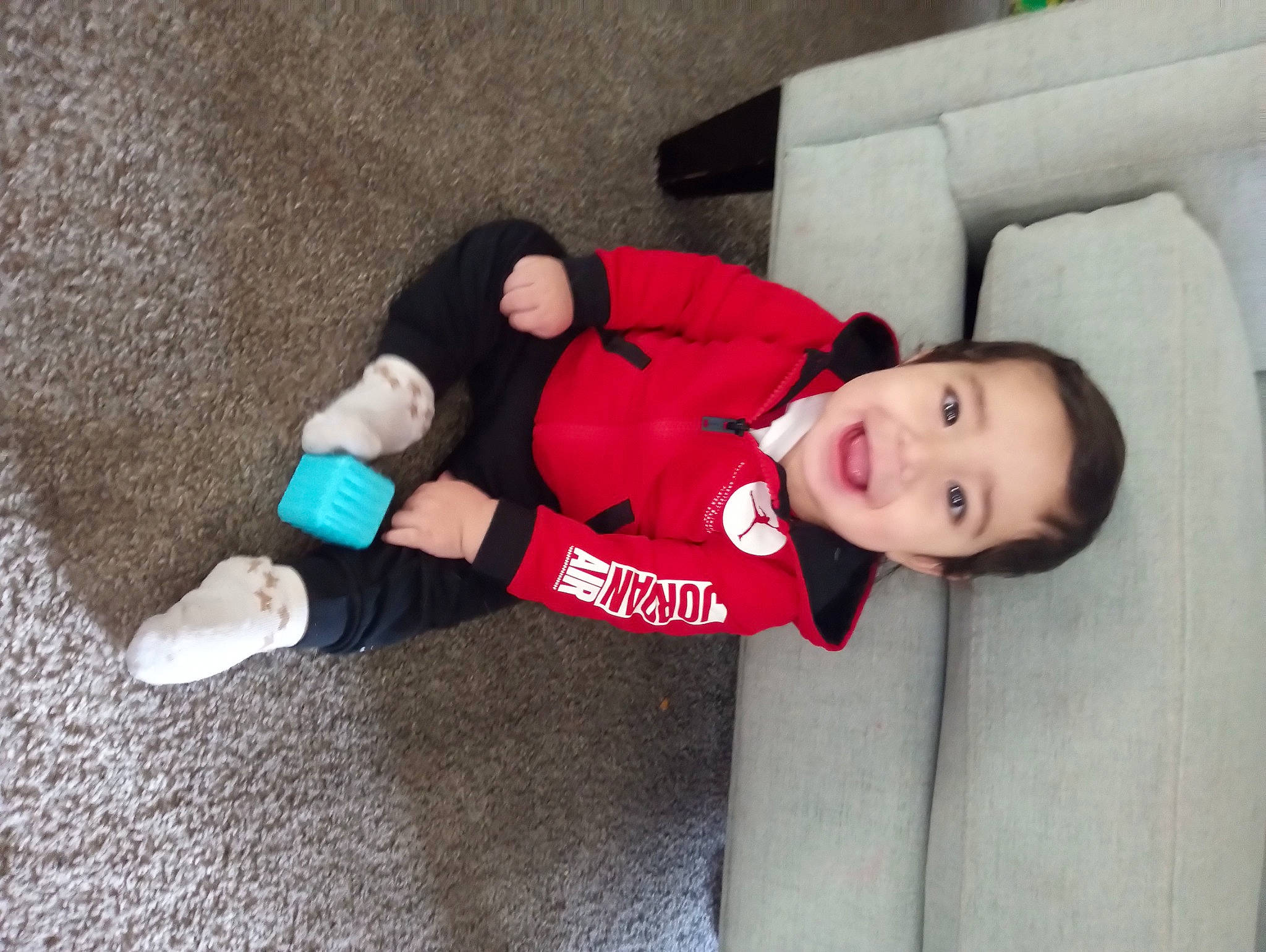 Julian joined the competition — help win amazing prizes! baby_products, baby_toddler_clothing, carmine, child, comfort, couch, flooring, fun, fur, glove, human_leg, joy, knee, lap, person, sleeve, smile, sock, thigh, toddler