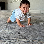 Raiden joined the competition — help win amazing prizes! baby, child, crawling, smiling, white_shirt, blue_shorts, carpet, floor, indoor, hallway, person, cute, happy, young, infant, toddler, skin, hair, eyes, hands