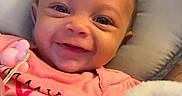 Sahara joined the competition — help win amazing prizes! baby, smiling, infant, pink_clothing, cute, happy, face, child, indoors, blanket, cushion, portrait, young_child, lying_down, closeup, human, skin, head, expression, comfort