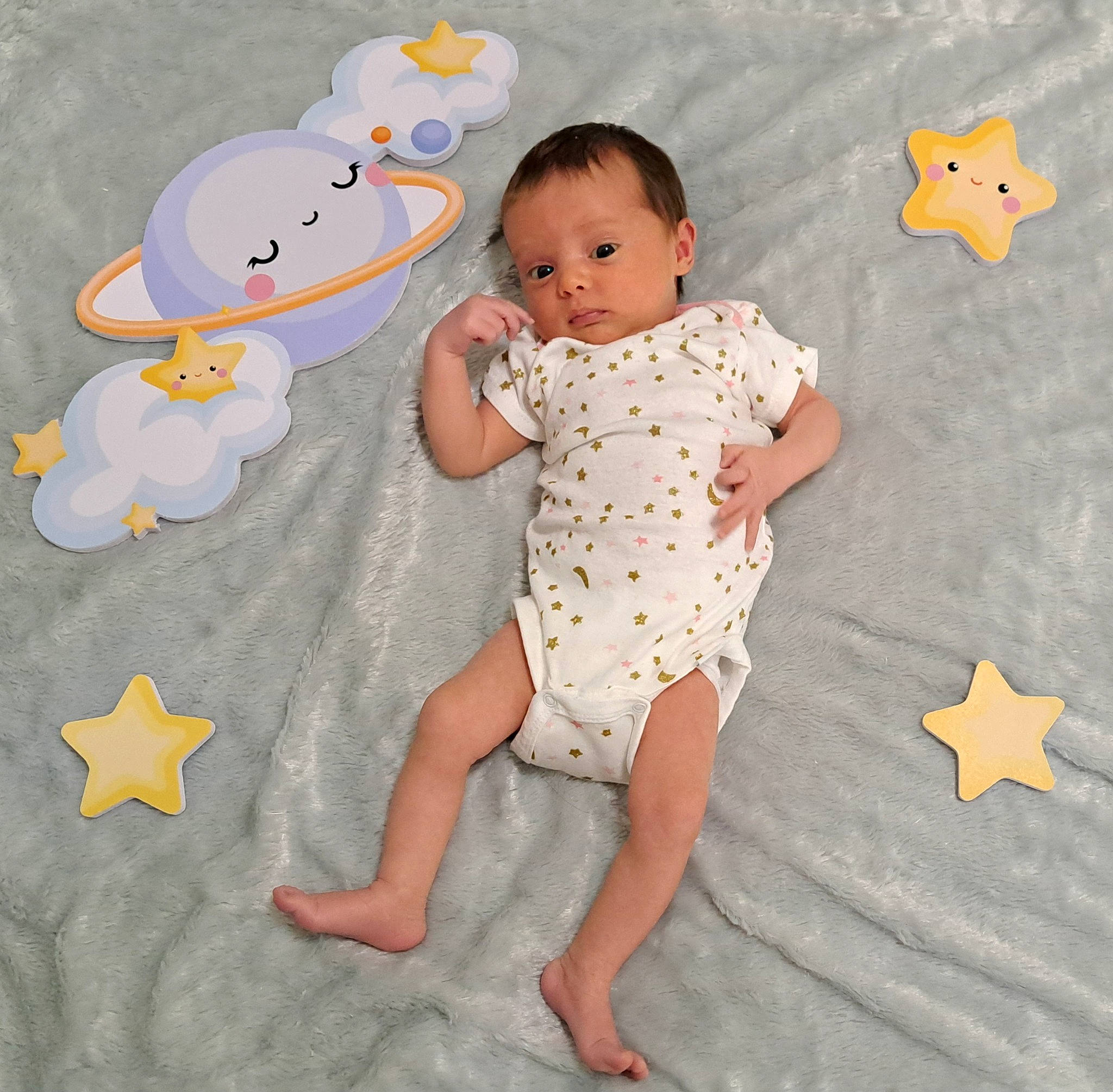 Aliza is registered to the contest to win money with this photo: arm, baby, baby_toddler_clothing, barefoot, child, circle, finger, flooring, foot, fun, happy, human_leg, infant_bodysuit, pattern, people_in_nature, person, play, skin, sleeve, thumb