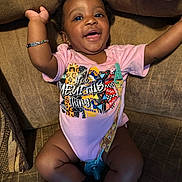 Jream joined the competition — help win amazing prizes! baby, child, infant, smiling, happy, onesie, bracelet, pacifier, bow, couch, furniture, indoor, person, cute, skin, expression, relaxing, sitting, clothing, home