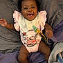 Jream joined the competition — help win amazing prizes! baby, infant, smiling, pink_outfit, cartoon_print, bandana, bed, blanket, purple_blanket, gray_blanket, socks, happy, cute, child, person, lying_down, indoors, playful, joyful, face