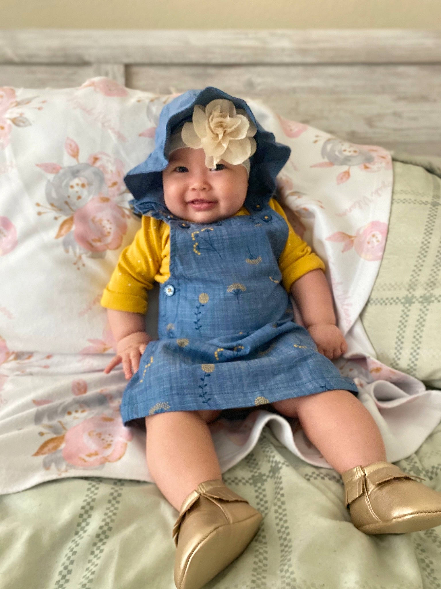 Keziah is registered to the contest to win money with this photo: baby, baby_toddler_clothing, child, dress, fashion_accessory, happy, headband, headwear, human_leg, joy, lap, leg, pattern, person, pink, purple, sitting, skin, sleeve, smile