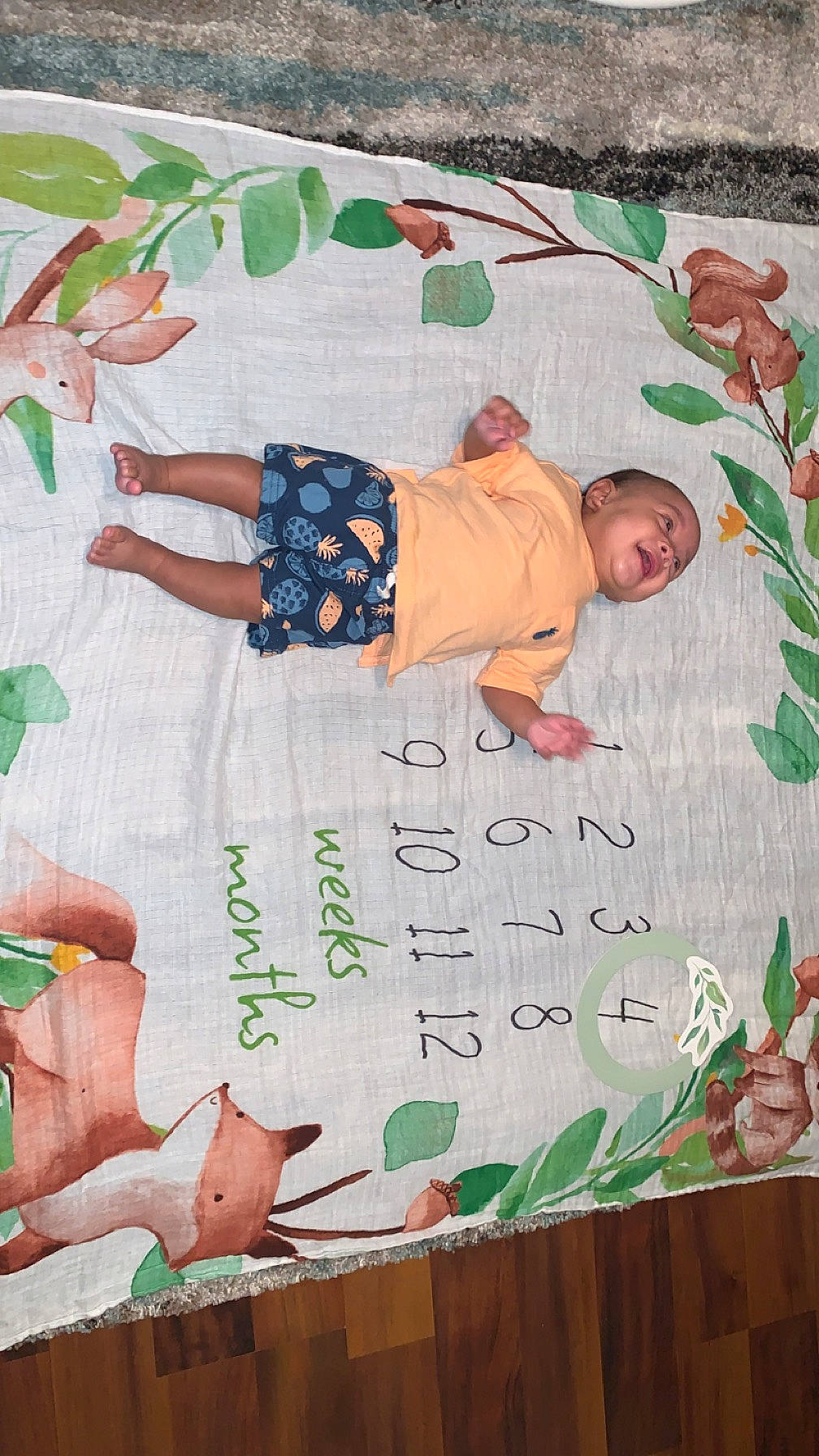 Malakai is registered to the contest to win money with this photo: adaptation, baby_toddler_clothing, child, font, green, handwriting, happy, leaf, line, linens, organism, pattern, people_in_nature, person, pink, product, textile, toddler, wall, white