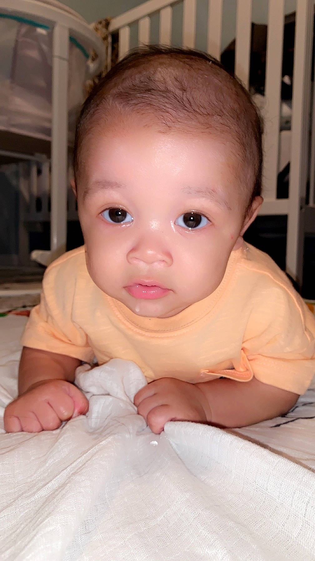 Malakai is registered to the contest to win money with this photo: baby, baby_toddler_clothing, cheek, child, comfort, eyelash, finger, floor, flooring, gesture, iris, lip, mouth, nail, nose, person, skin, sleeve, thumb, toddler