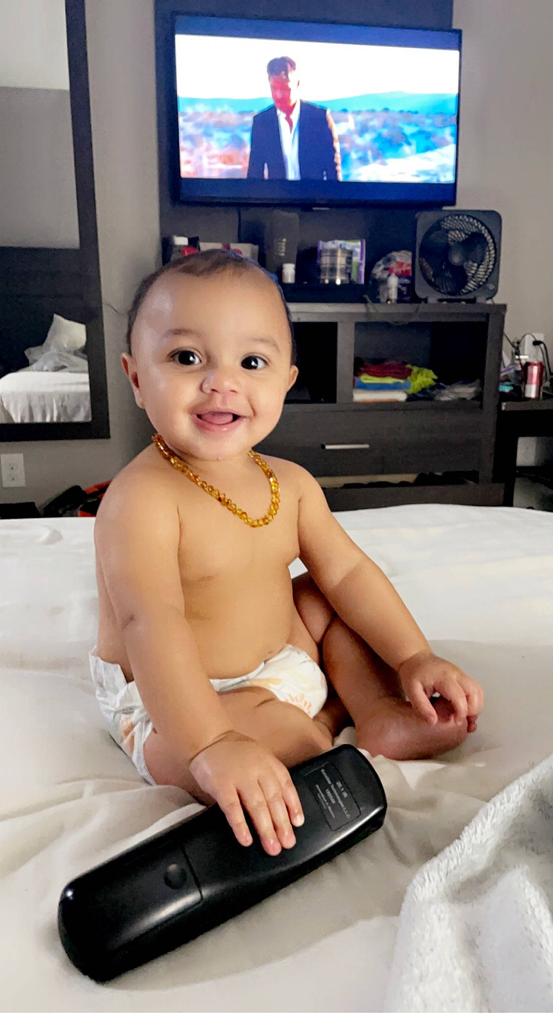 Kaylin is registered to the contest to win money with this photo: baby, cheek, chest, comfort, electronic_device, finger, gadget, happy, head, iris, joint, joy, muscle, person, shelf, shoulder, skin, smile, technology, television