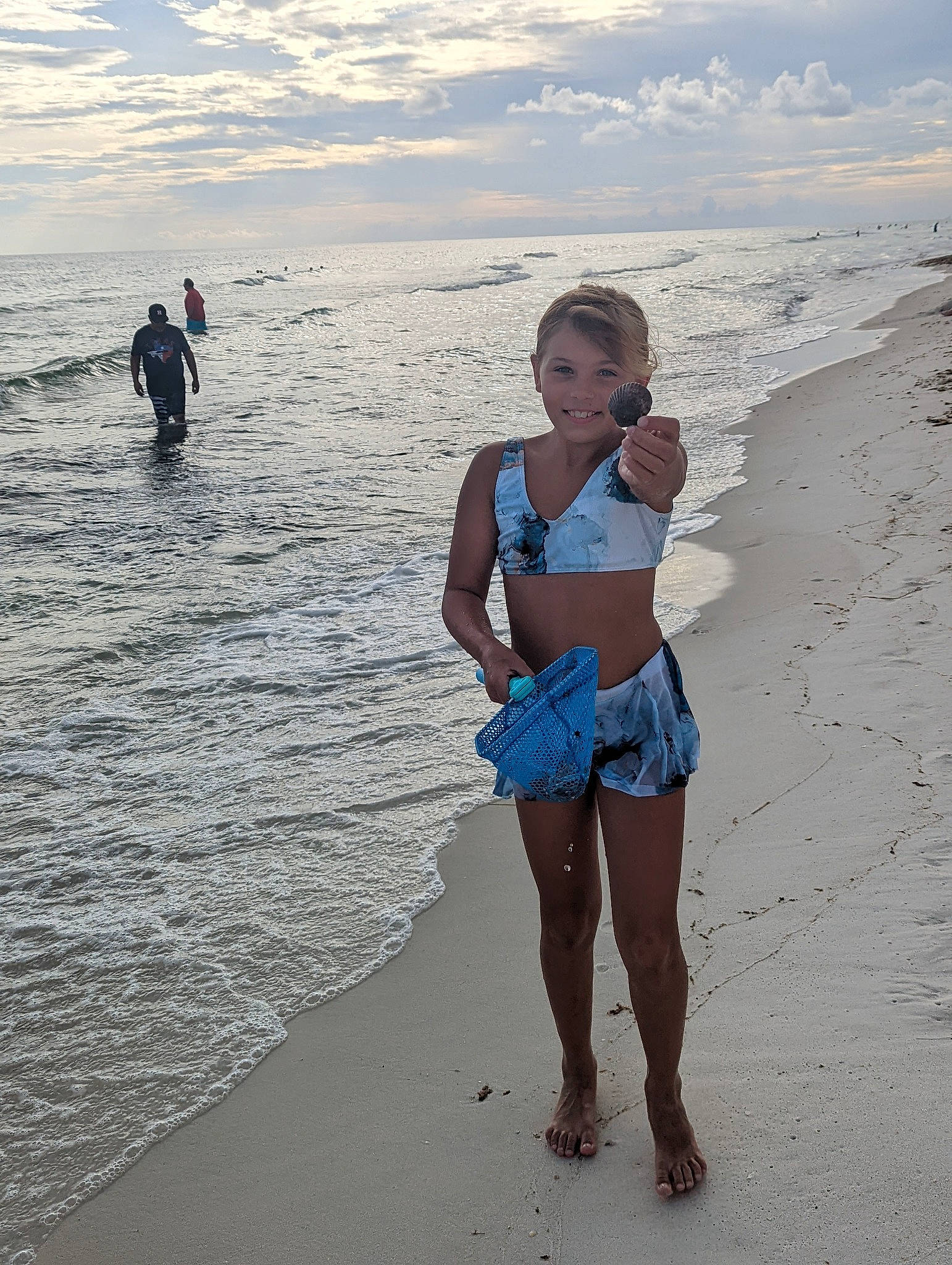 Braelynn is registered to the contest to win money with this photo: azure, beach, body_of_water, cloud, coastal_and_oceanic_landforms, flash_photography, fun, happy, horizon, human, joy, natural_environment, people_in_nature, people_on_beach, person, sand, sky, standing, summer, thigh