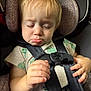 Aurora is registered to the contest to win money with this photo: toddler, car_seat, child, pout, sleepy, straps, clothing, hands, blonde_hair, baby, seat_belt, sitting, indoor, closeup, person, cute, expression, young_child, infant, car_interior
