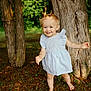 toddler, child, smiling, barefoot, dress, pigtails, trees, forest, outdoor, grass, nature, sunlight, happy, young_child, person, standing, daylight, playful, cute, portrait