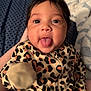 Eliana joined the competition — help win amazing prizes! baby, infant, face, tongue_out, leopard_print, onesie, hair, cute, playful, child, person, portrait, cozy, quilt, bed, hand, skin, expression, smile, young