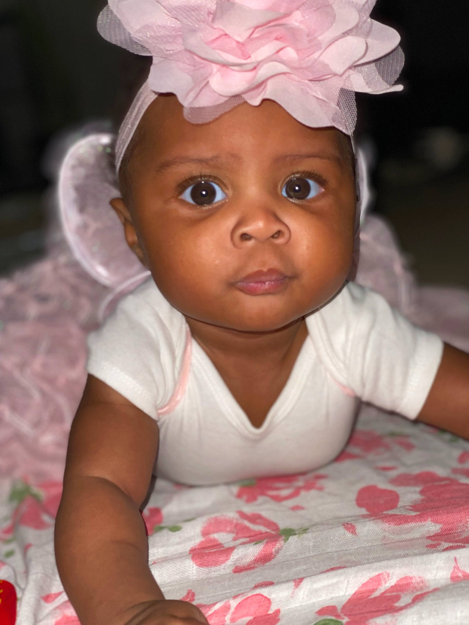 Nairobi is registered to the contest to win money with this photo: baby, baby_toddler_clothing, cheek, child, chin, eye, eyebrow, fashion_accessory, flash_photography, fun, happy, head, headpiece, headwear, lip, nose, person, petal, pink, skin