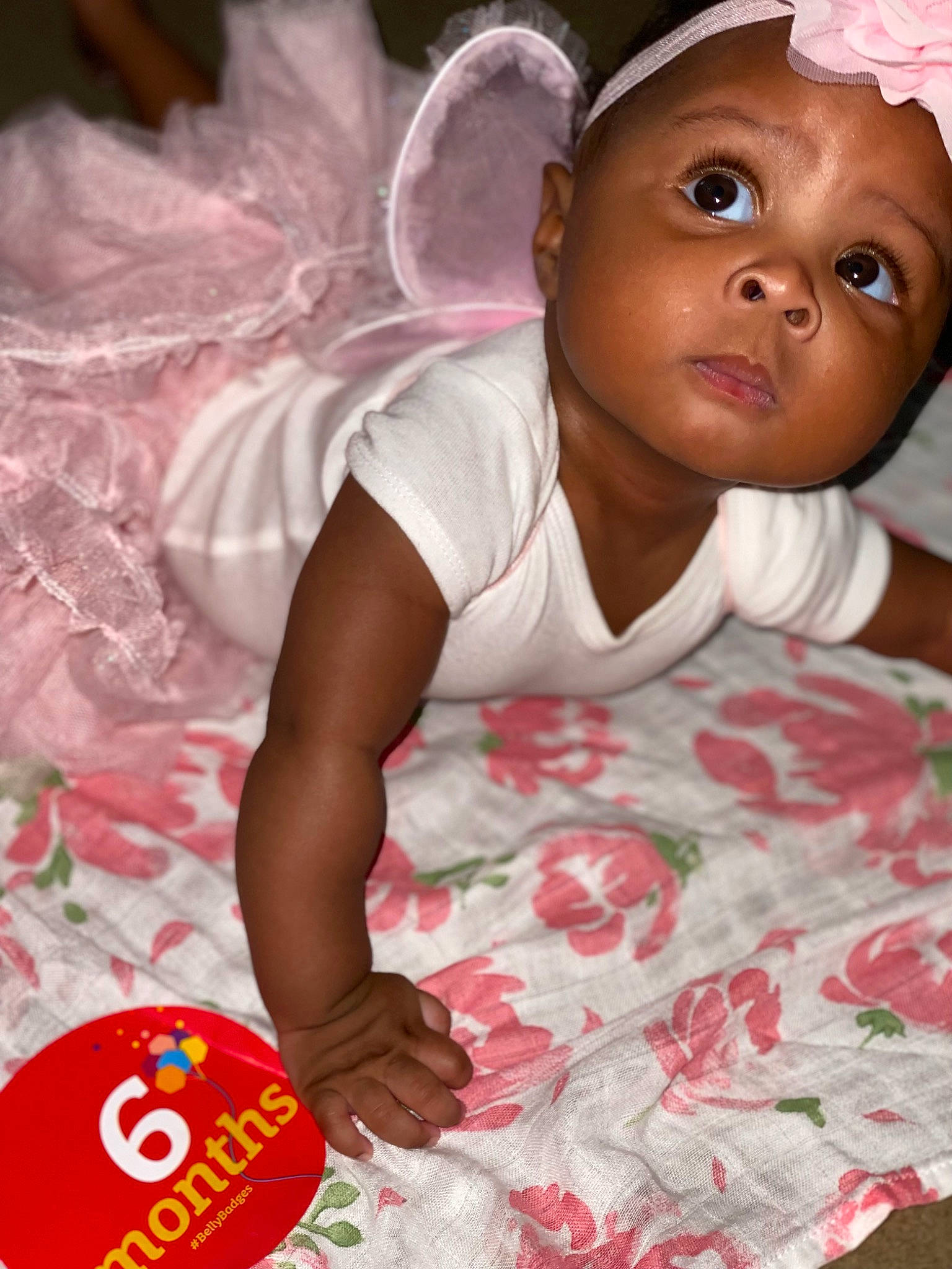 Nairobi is registered to the contest to win money with this photo: baby, baby_products, baby_toddler_clothing, beauty, cheek, child, event, facial_expression, fun, happy, hat, headpiece, linens, pattern, person, pink, product, skin, stop_sign, toddler