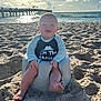 baby, beach, sand, ocean, pier, sunshine, child, seat, smiling, water, sky, clouds, sunlight, happy, outdoor, vacation, relaxation, footwear, clothing, summer