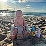 Carter joined the competition — help win amazing prizes! baby, beach, sand, ocean, sunlight, pier, toy, smile, infant, blue_sky, clouds, water, seat, playful, happy, sunshine, summer, child, outdoor, vacation