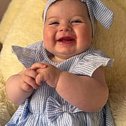 Yeimy participe au concours pour gagner de l'argent avec cette photo : baby, child, smiling, blue_striped_dress, headband, bow, hands, cute, happy, infant, portrait, sitting, blanket, soft_texture, closeup, cheeks, face, clothing, indoors, skin