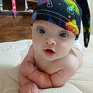 Miracle joined the competition — help win amazing prizes! baby, infant, hat, mushroom_pattern, blue_eyes, bare_chest, curious_expression, indoor, mattress, wooden_furniture, child, cute, portrait, skin, person, headwear, colorful, closeup, young, resting