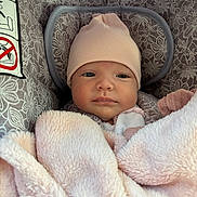 Capucine participe au concours pour gagner de l'argent avec cette photo : baby, infant, blanket, hat, face, eyes, person, child, carseat, pattern, pink, soft, cozy, cute, newborn, portrait, wrapped, warm, indoors, resting