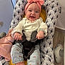 Capucine a rejoint le concours — aidez-le/la à gagner de superbes lots ! baby, baby_seat, child, clothing, cushion, cute, floor, floral, happy, headband, indoor, infant, jeans, pattern, person, pink, seat, smiling, socks, wood_floor